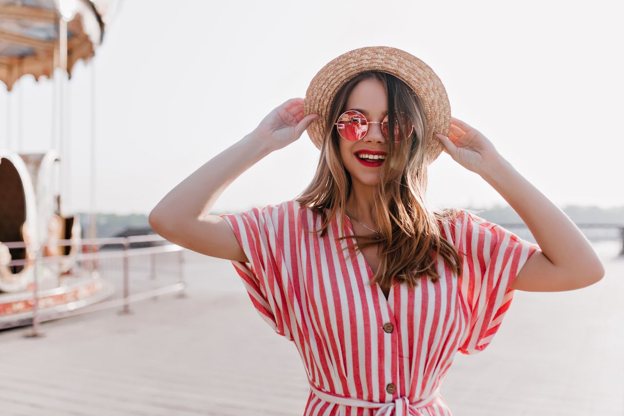 amazing-white-female-model-touching-her-hat-sky-background-smiling-elegant-young-woman-striped-dress-enjoying-good-summer-weekend.jpg