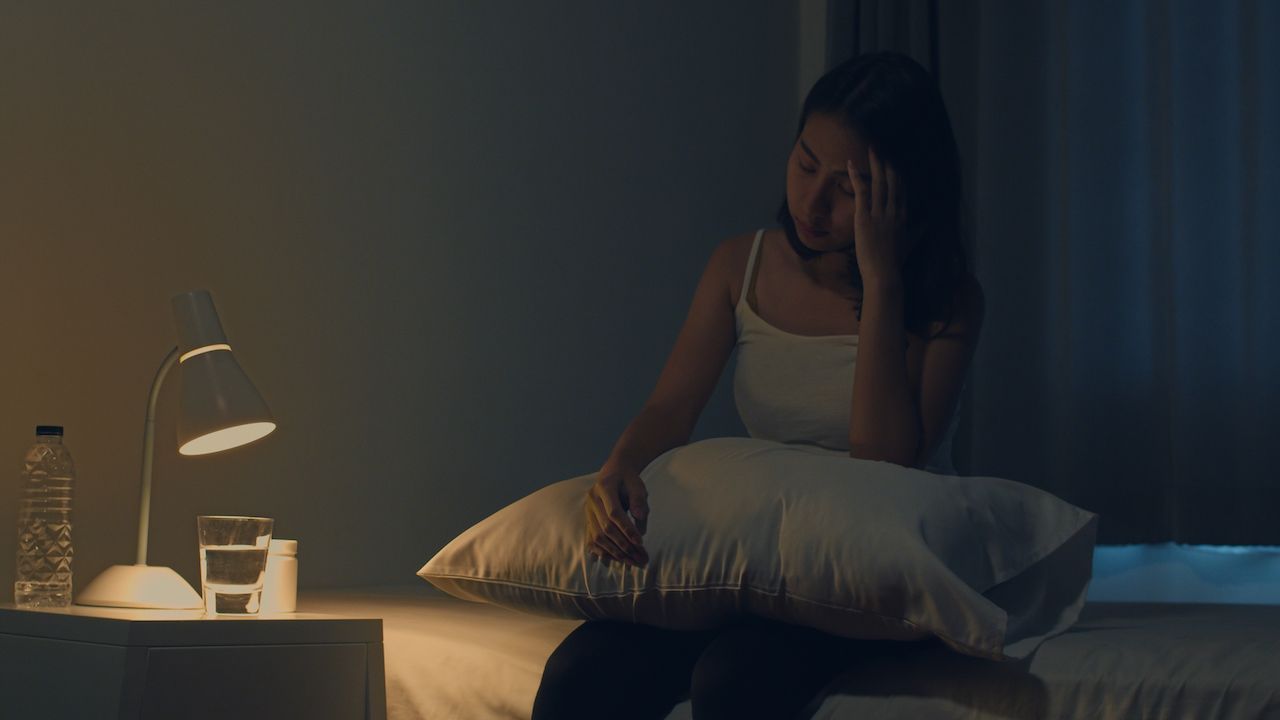 beautiful_asian_young_woman_sitting_bed_take_sleeping_pill_night_medicine_bedroom_unhealthy_sick_indian_female_suffers_from_insomnia_headache_depressed_girl_holds_antidepressant_meds_858b9074c1.jpeg