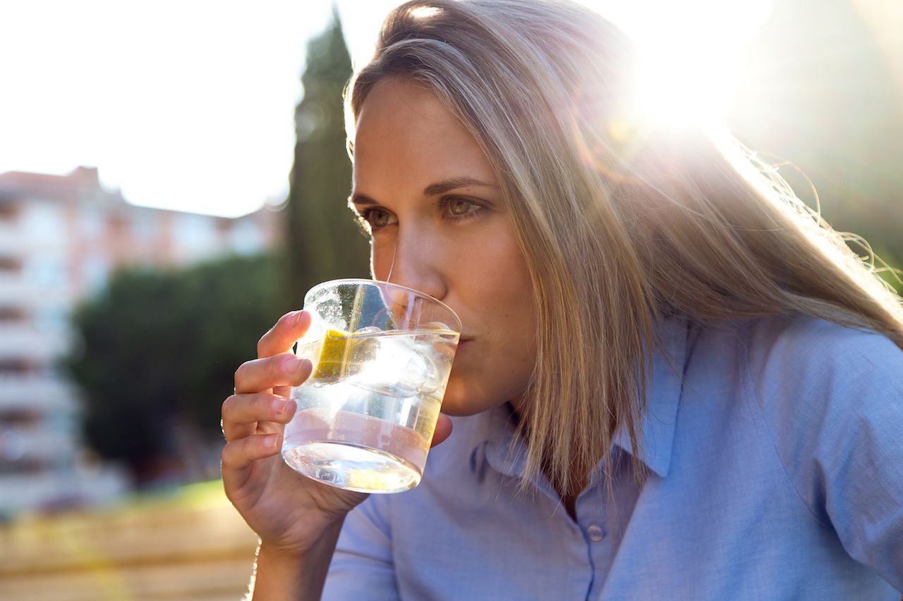 beautiful-young-woman-drinking-soda-restaurant-terrace.jpg