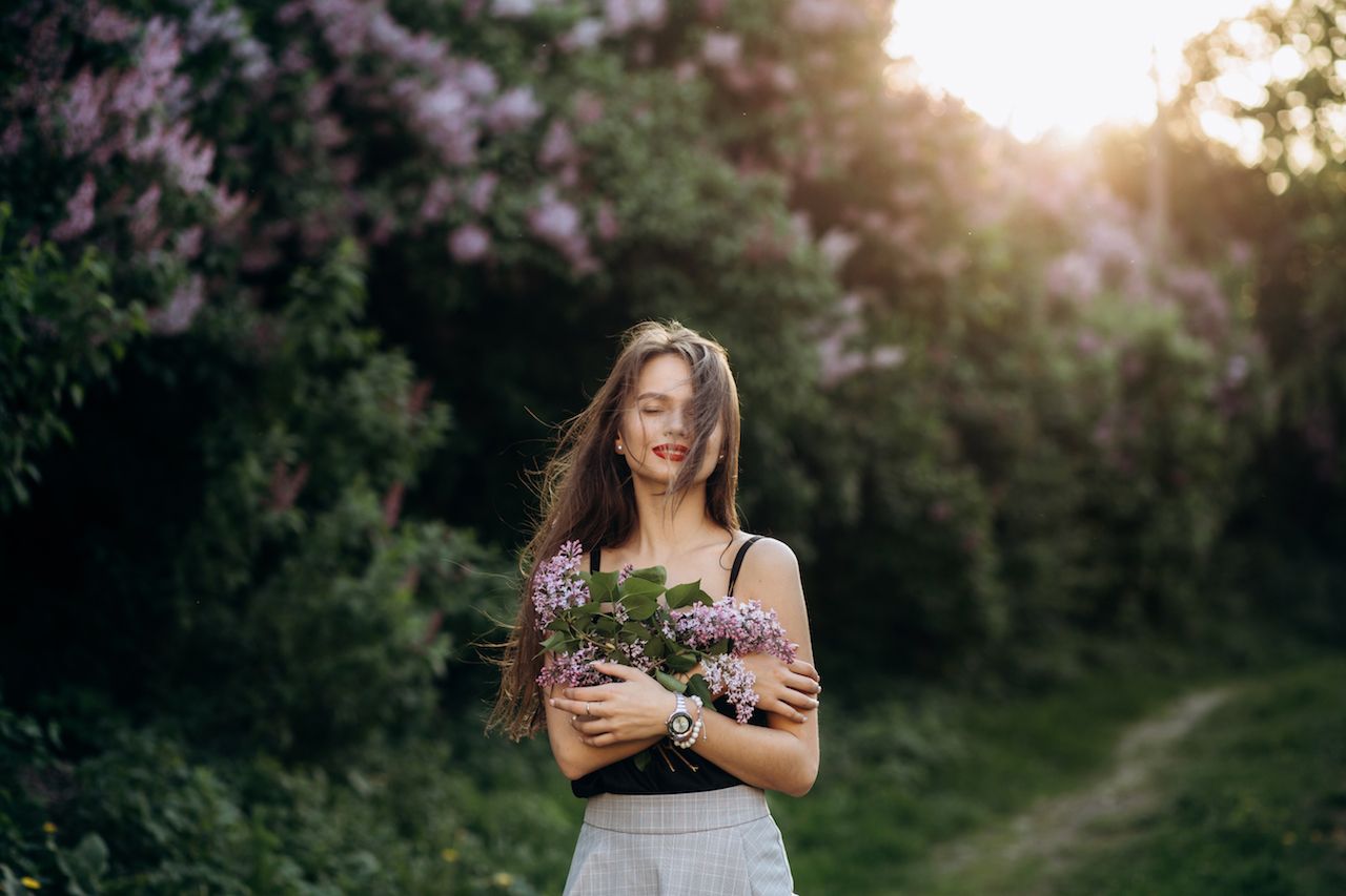 charming-girl-stands-park-keeps-bouquet.jpg