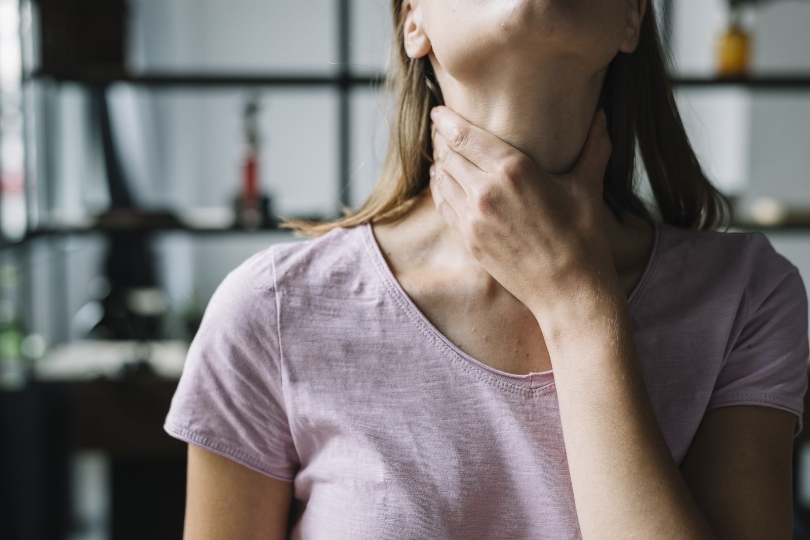 close-up-woman-s-hand-touching-her-neck_1600x1068.jpg