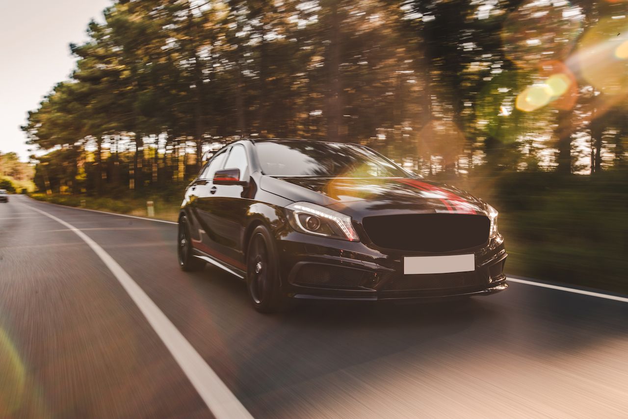 front-view-black-luxury-sedan-road.jpg