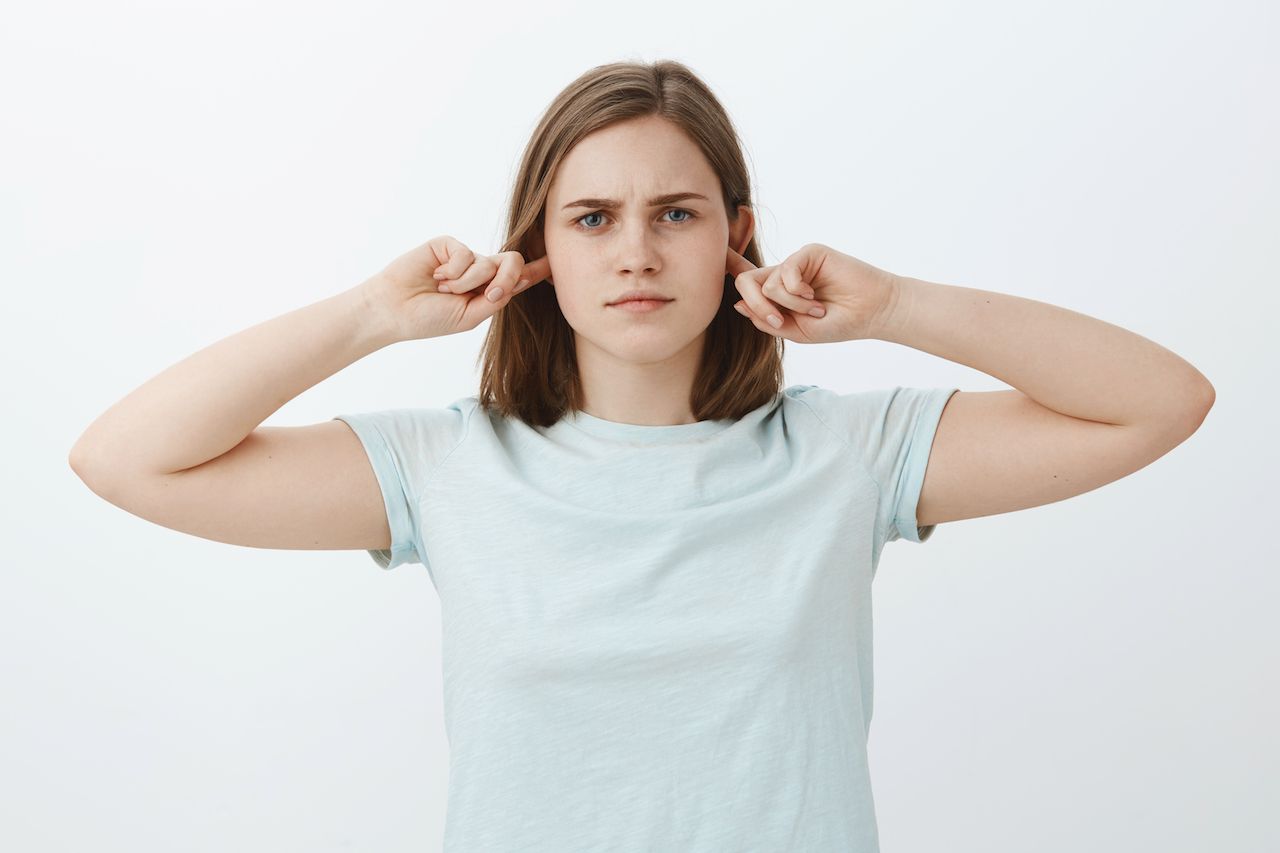 girl-going-listen-shutting-up-ears-intense-serious-looking-bothered-woman-covering-hearing-with-index-fingers-standing-indifferent-uninvolved-unwilling-continue-conversation.jpg