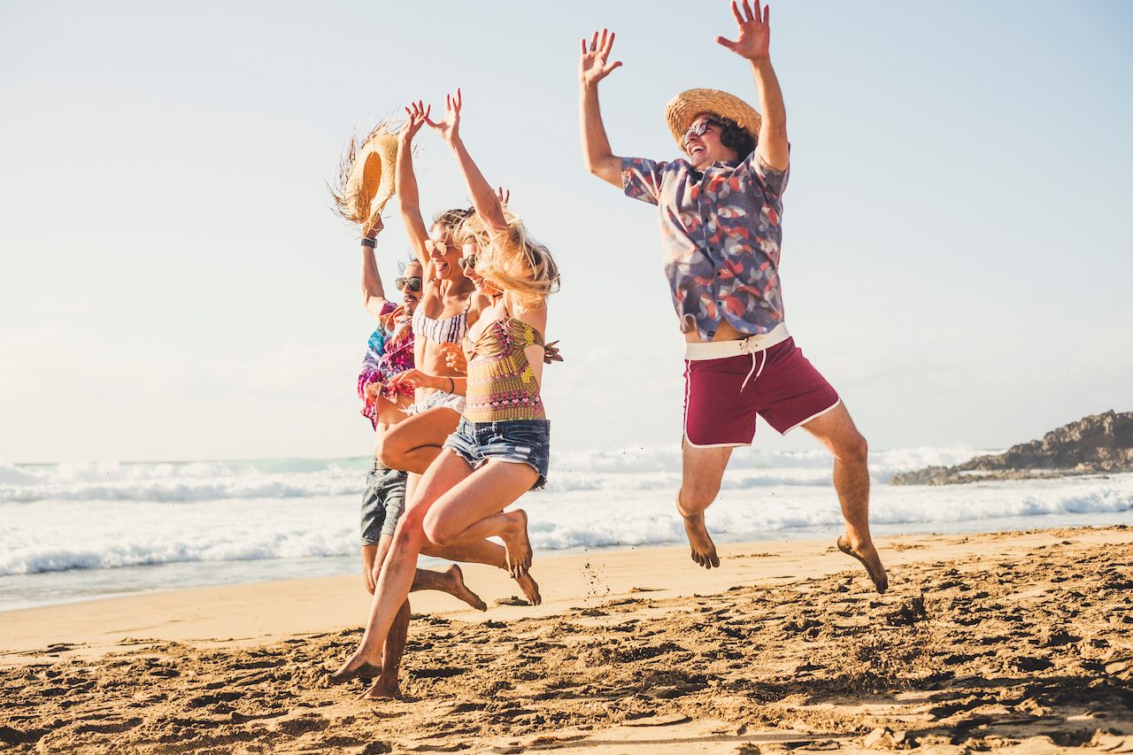 group-happy-tourist-jump-beach.jpg