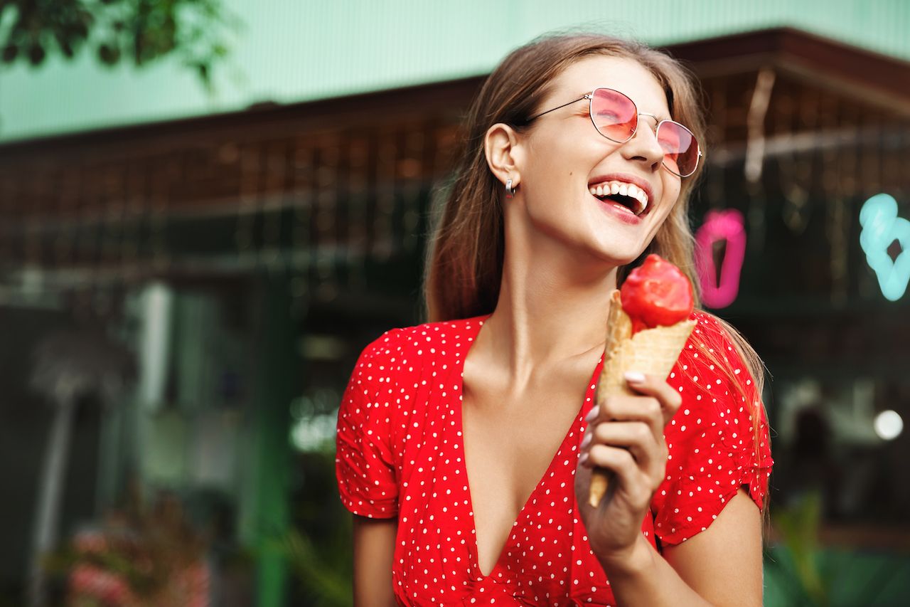 happy-young-woman-eating-sweets-summer-vacation.jpg