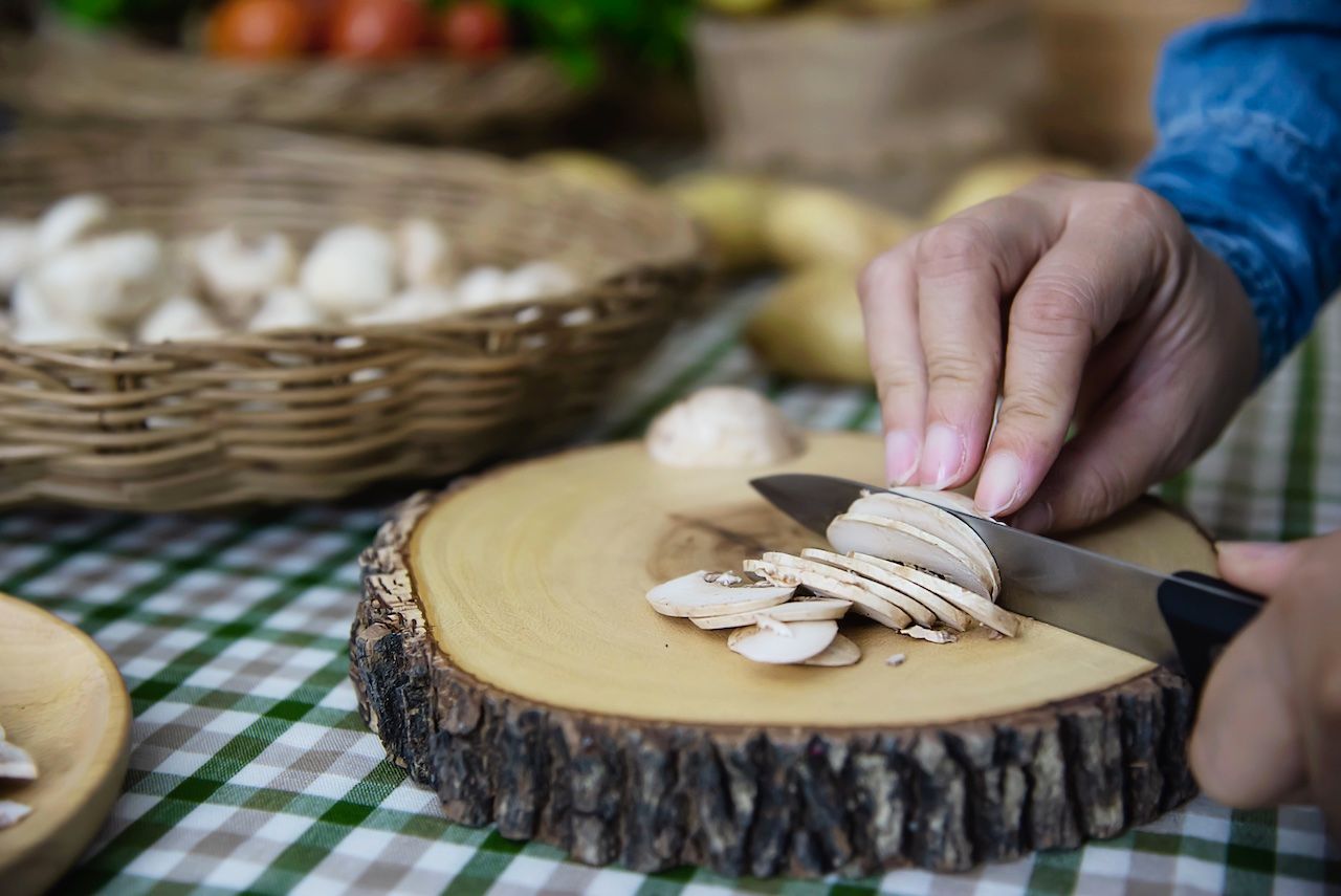 lady-cooks-fresh-champignon-mushroom-vegetable-kitchen.jpg