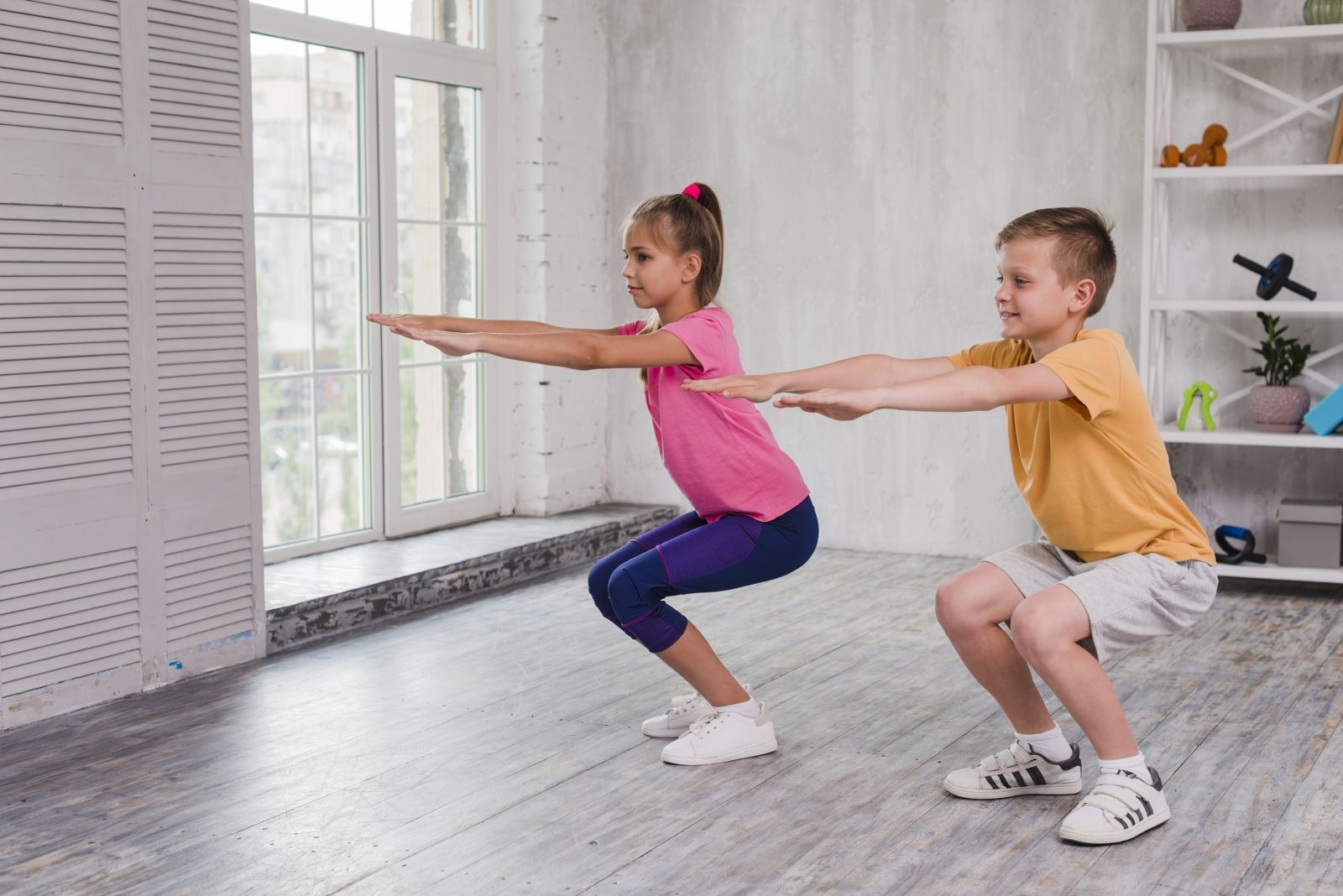 portrait-boy-girl-exercising-home_1600x1068.jpg