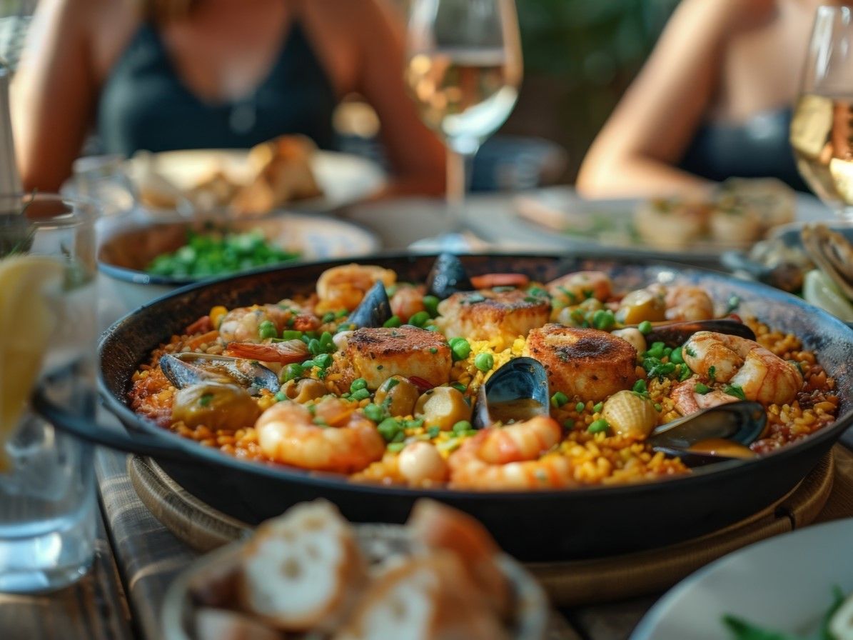 table-set-with-delicious-paella-dish-filled-with-seafood-accompanied-by-glass-wine (1).jpg