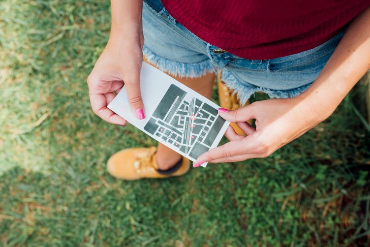 top-view-woman-holding-directions-card.jpg