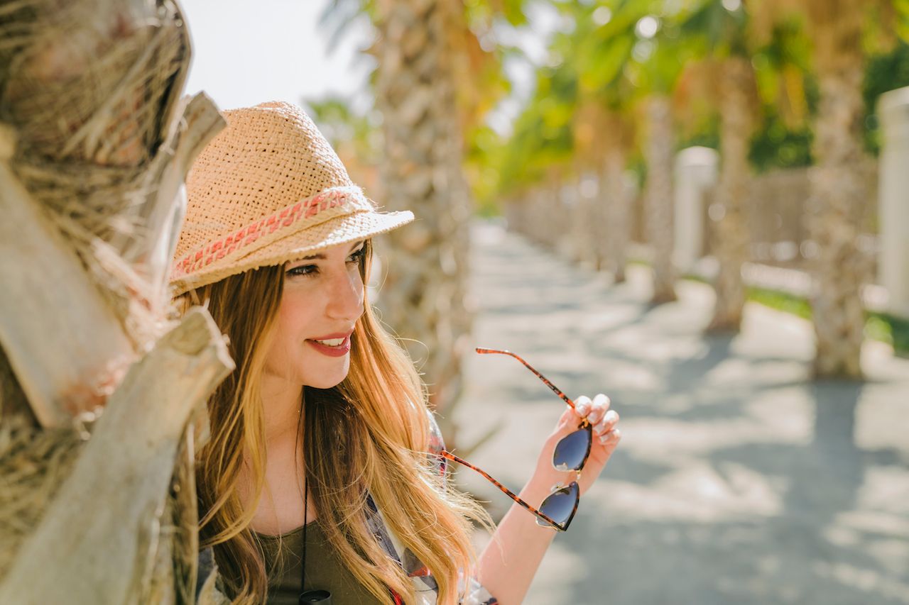 traveler-posinng-with-sun-glasses-palm-trees.jpg