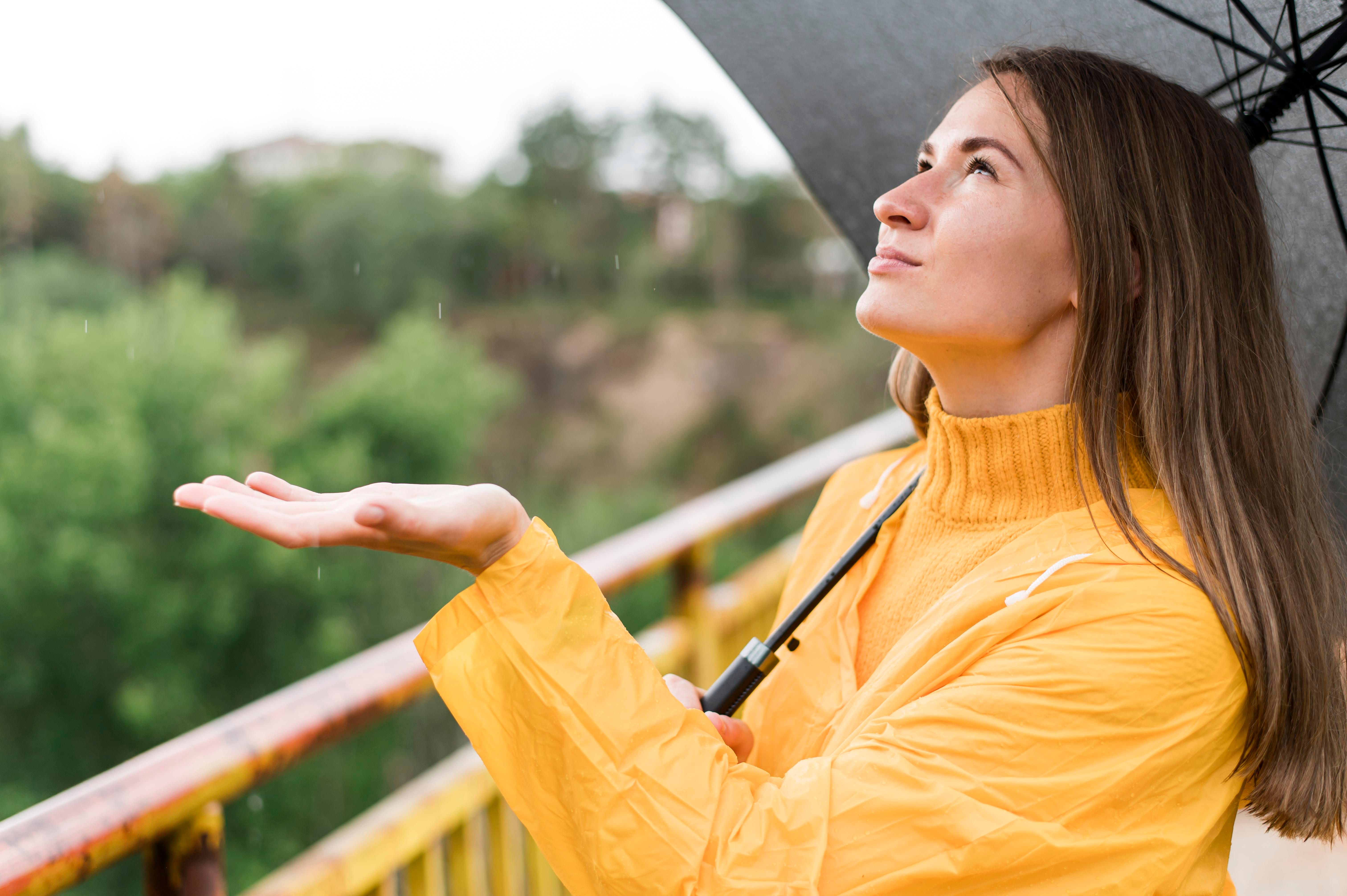 woman-feeling-rain-with-her-hand.jpg