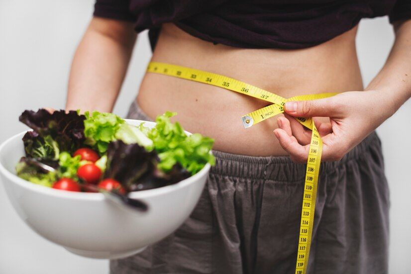 woman-measuring-her-tummy-weight_53876-13564.jpeg
