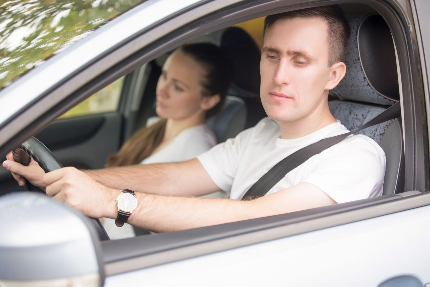 young-male-driver-looking-side-view-mirrors.jpg