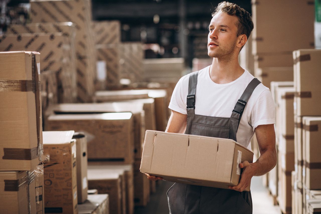 young-man-working-warehouse-with-boxes.jpg