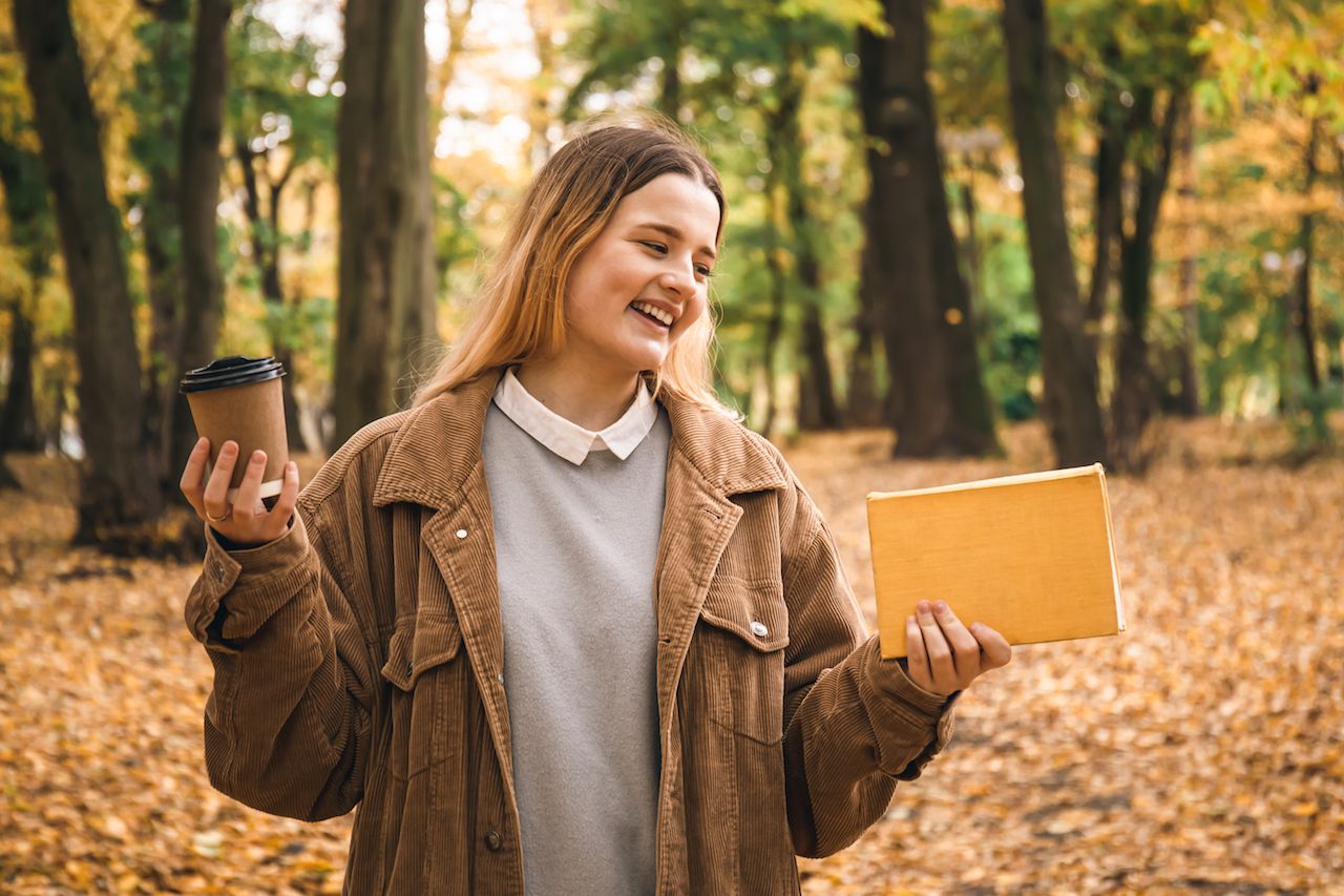 young-woman-student-with-book-cup-coffee-autumn-park.jpg